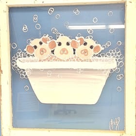 "Pigs in a Tub" painted on an antique wooden window item
