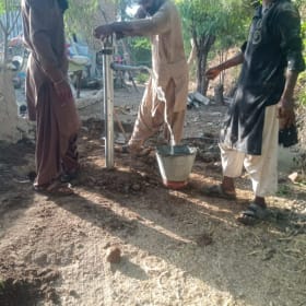 Manual hand pump in a remote village item