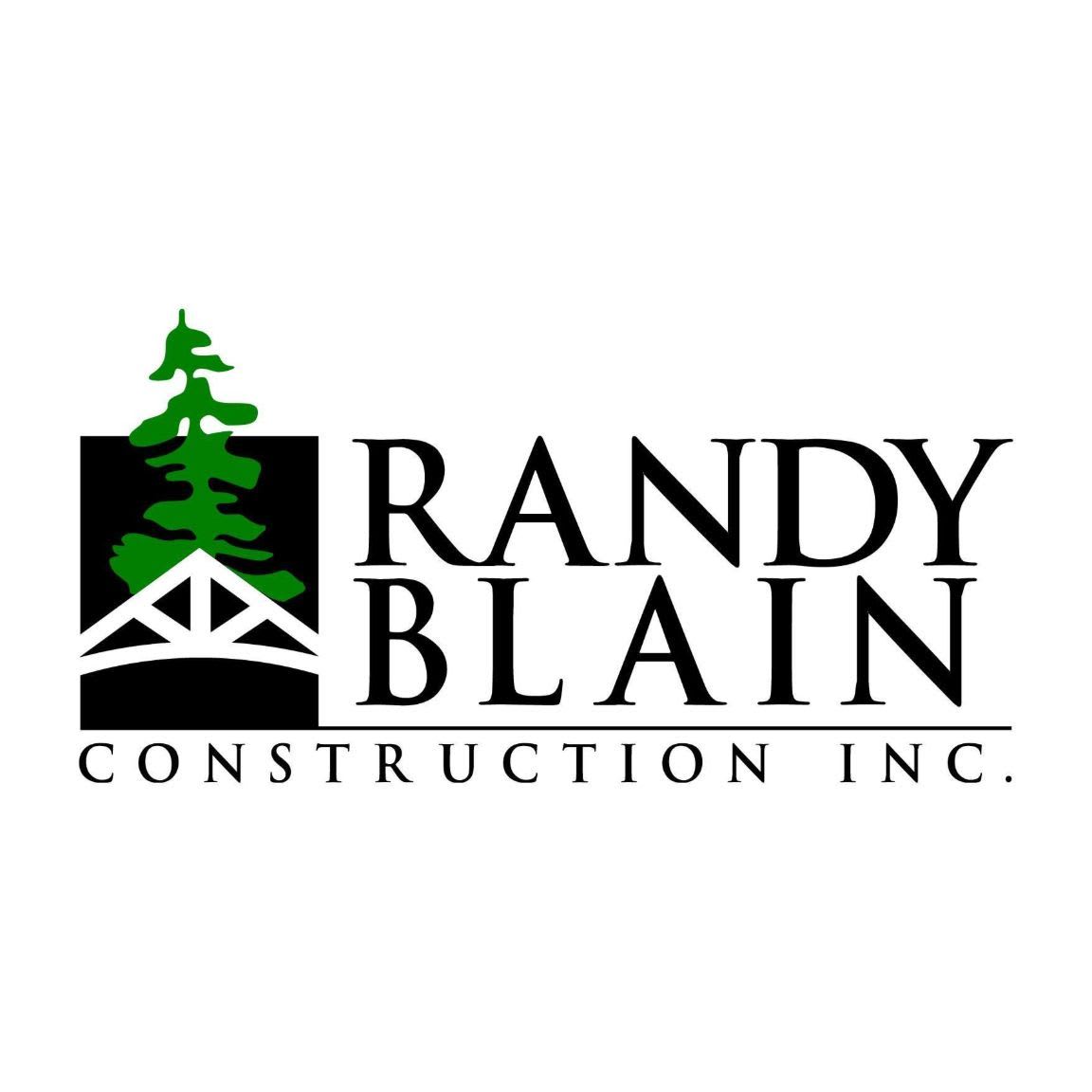 A green evergreen tree and a white truss structure are in the foreground, with the black text "RANDY BLAIN CONSTRUCTION INC." in the background.