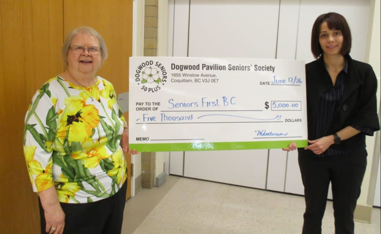 Marie-Noël Campbell, Executive Director of Seniors First BC, ans Marion Anderson from Dogwood Pavilion Seniors' Society hold a large cheque for $5000.