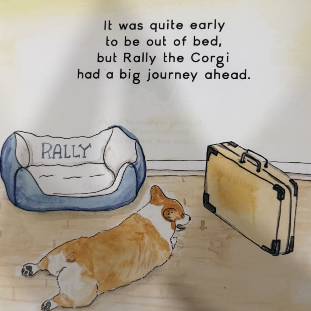 Watercolor page from the book: Rally the corgi stretched out beside his dog bed and a packed suitcase