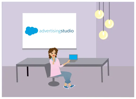 Linda seated at a table on her laptop presenting an Advertising Studio presentation