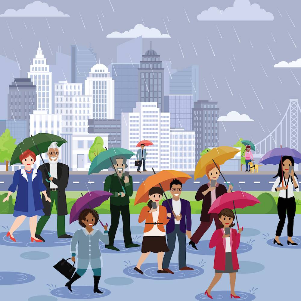 People walking to work in the rain with umbrellas with the San Francisco skyline in the background