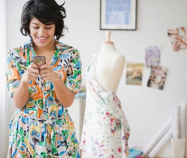 Dress shop owner shopping for inventory online.