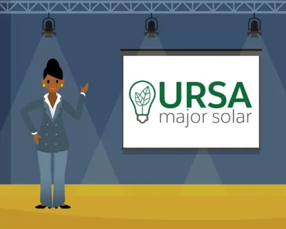 Sita Nagappan-Alvarez, the CEO of Ursa Major Solar, standing on a stage in front of the company’s logo