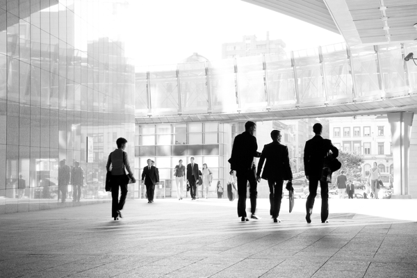 Business people crossing the lobby of an office building