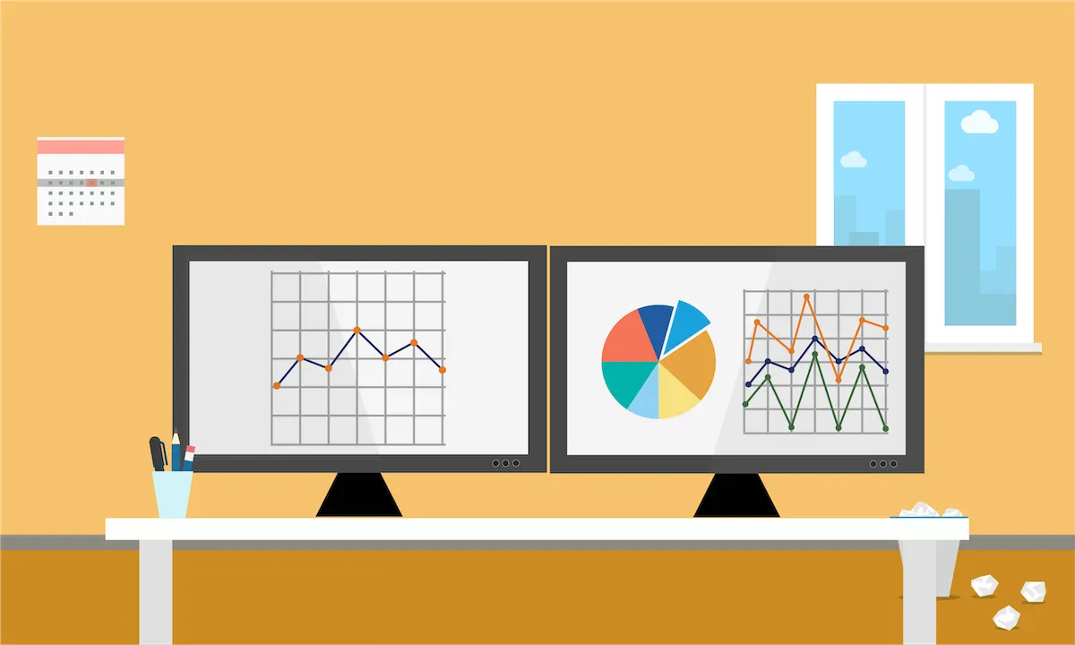 Computer screens in an office display colorful line graphs and a pie chart