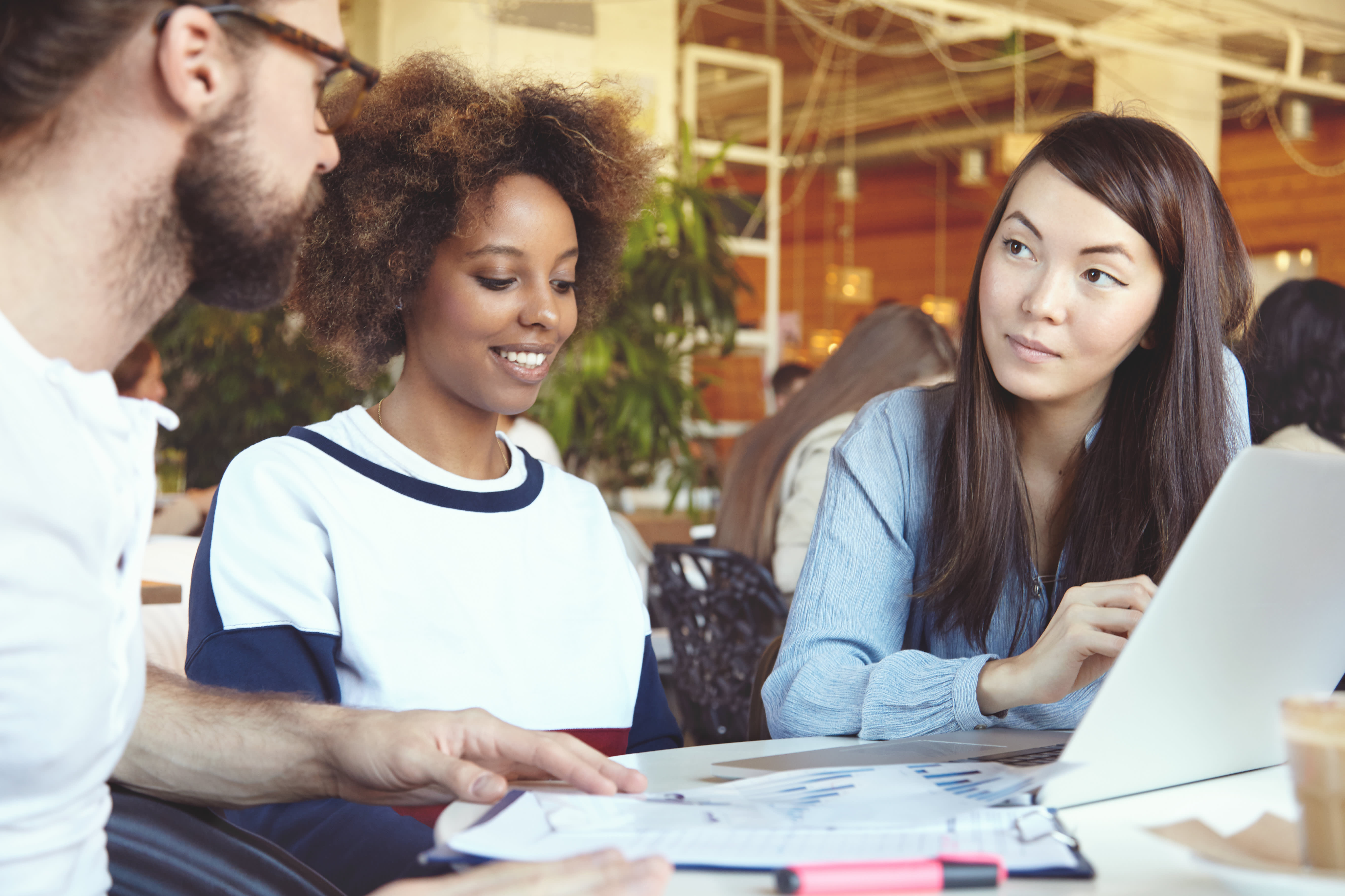 Two sales people sitting with their customer