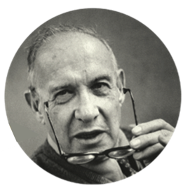 眼鏡を手に持っている Peter Drucker の写真。