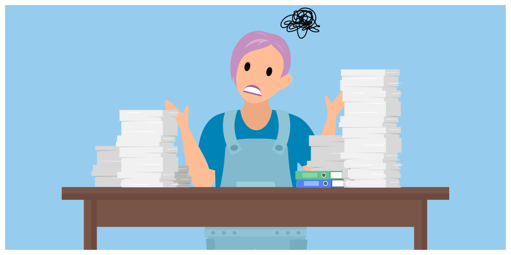 デスクの前でファイルの山に圧倒されている従業員。