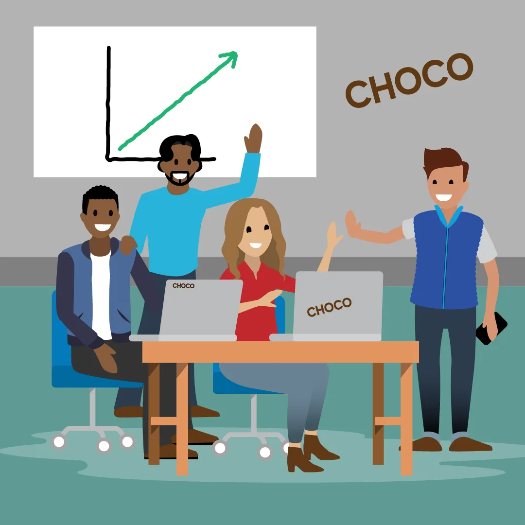 Emma und ihr Team von der Choco Chocolate Company sitzen um einen Tisch, auf dem Laptops stehen, lächeln und klatschen sich ab.