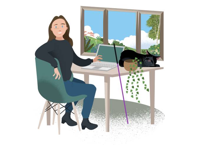 Cala sitting at her laptop, with a purple cane leaning on the desk.