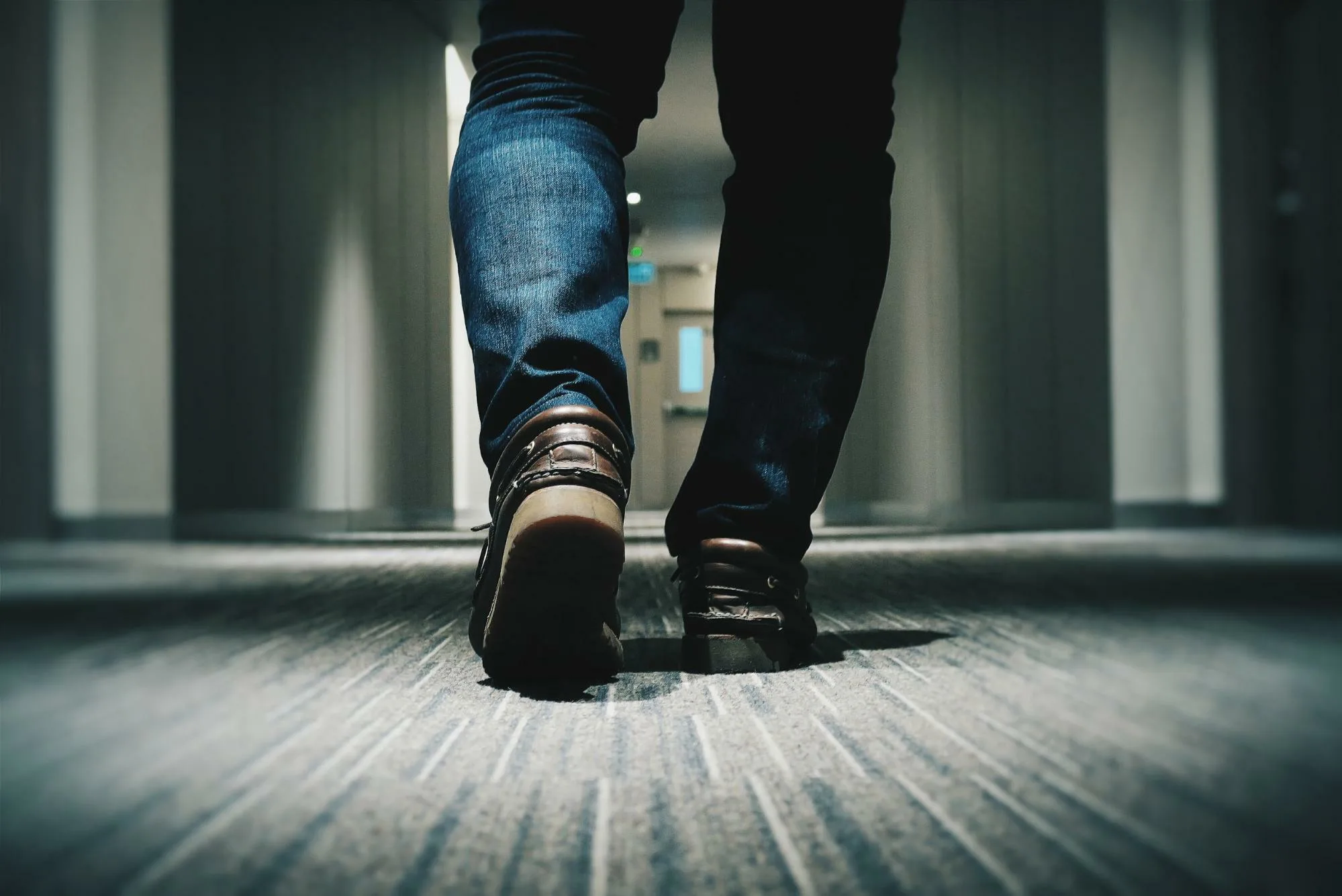 Photo of legs walking down a hall