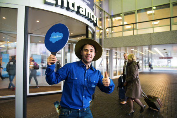 A man at Dreamforce with a Salesforce squash paddle