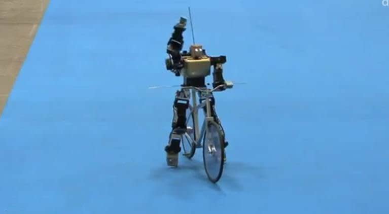 Robot riding a bike.