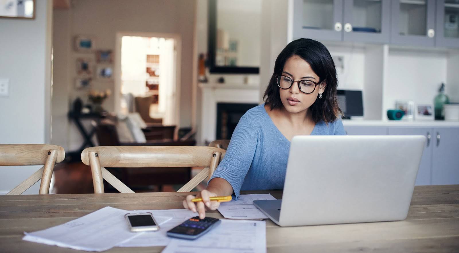 A woman at a computer completing a project.