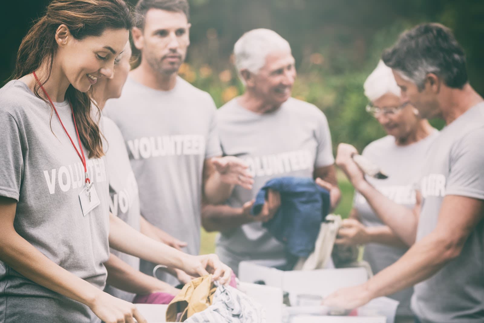 A photo of people wearing volunteer T-shirts gathered.