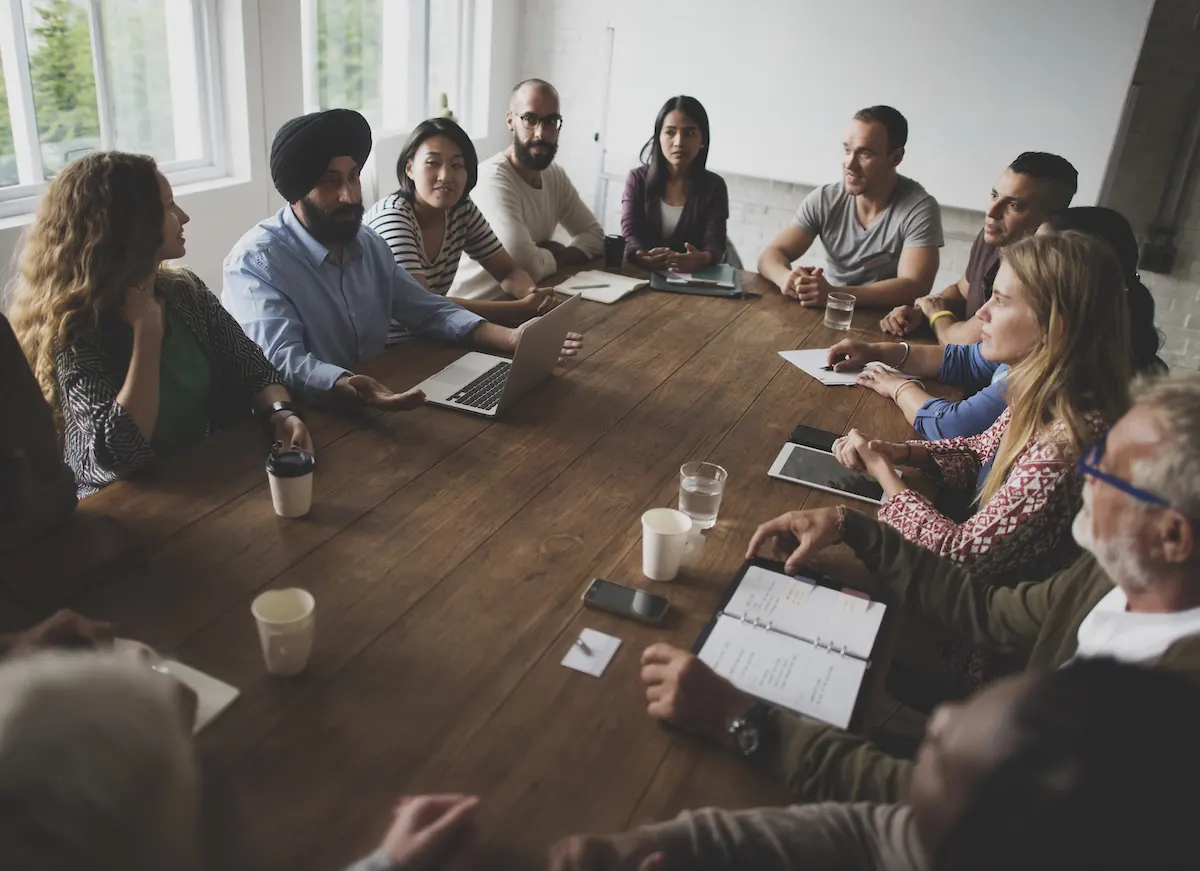 Sales operations team meeting with sales reps in a conference room.