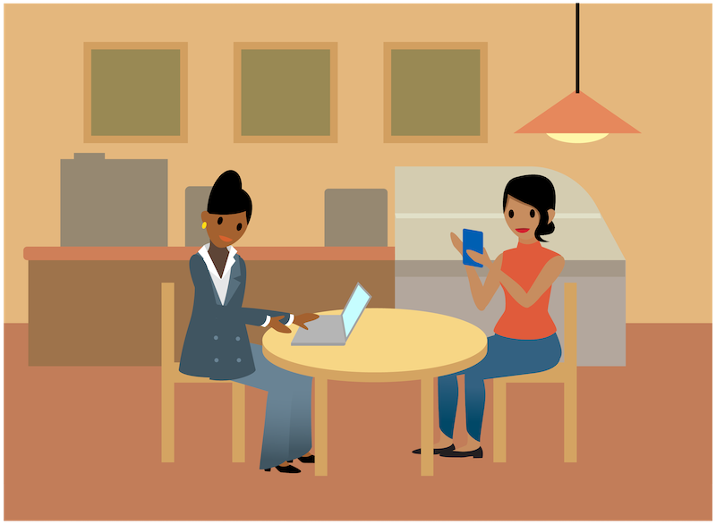 Sita und Maria arbeiten in einem Café an ihren Laptops und Mobiltelefonen.