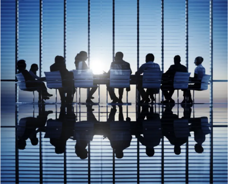 Business partners sitting around a table in a sunlit room