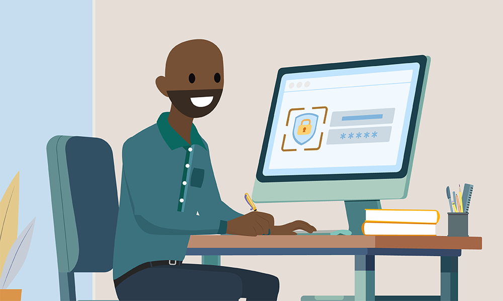 Calvin が机の前に座り、机にはコンピューターのモニターと山積みの本があります。