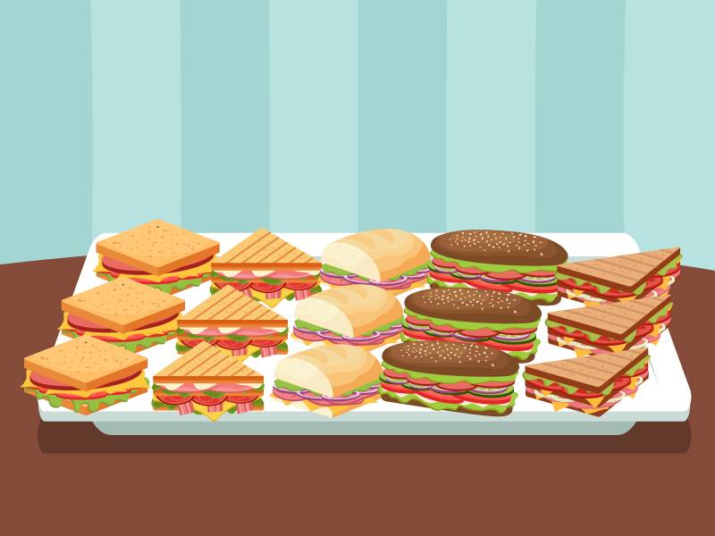 A tray loaded with different kinds of sandwiches.