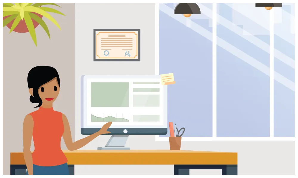 A female office worker pointing to a graph on her desktop computer.