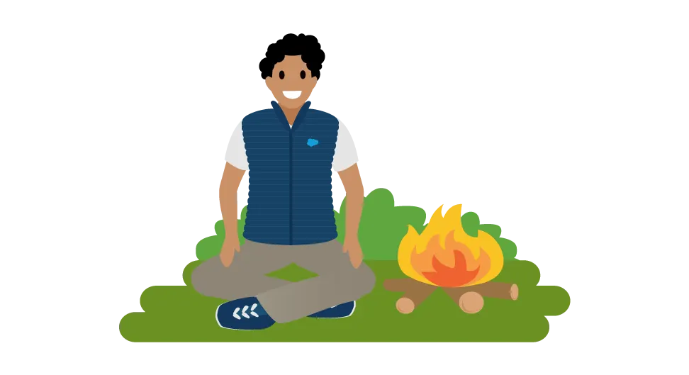 Image d’un employé assis près d’un feu de camp.