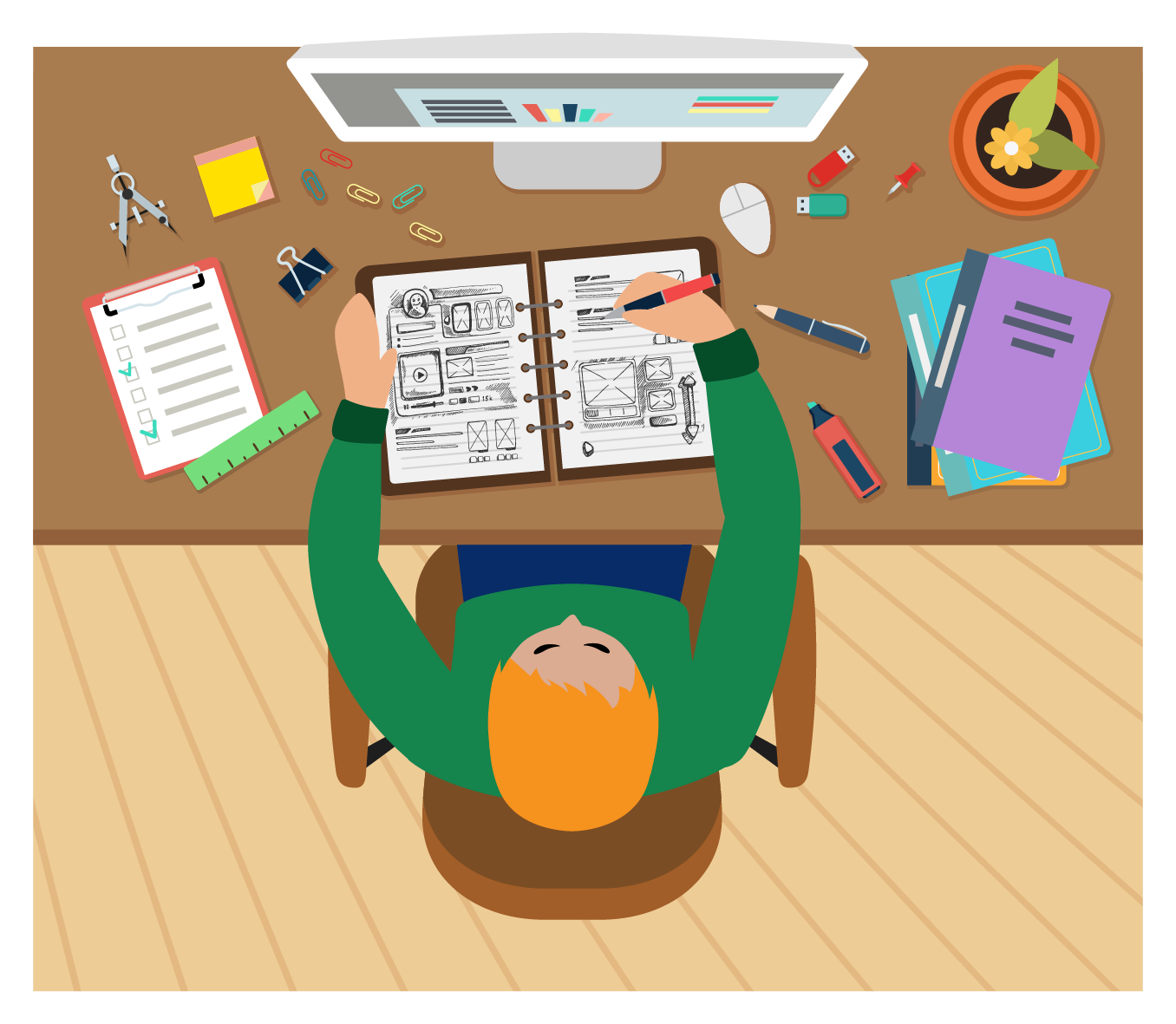 ある人がデスクでスケッチブックに描画しています。