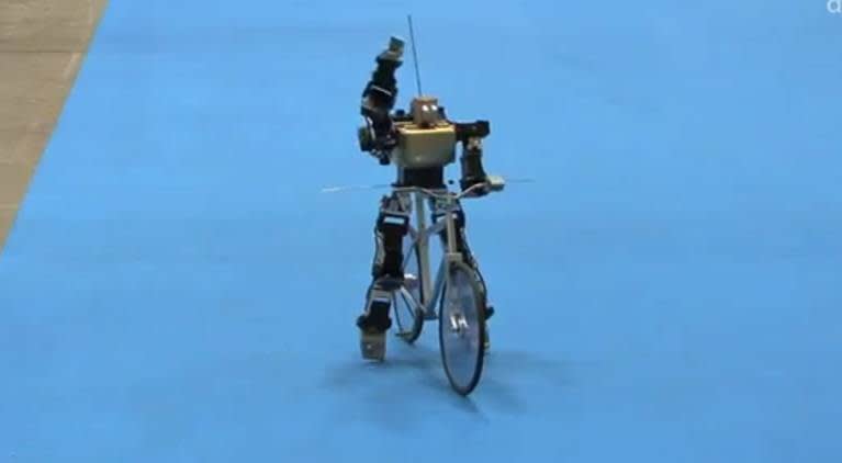 Robot riding a bike.