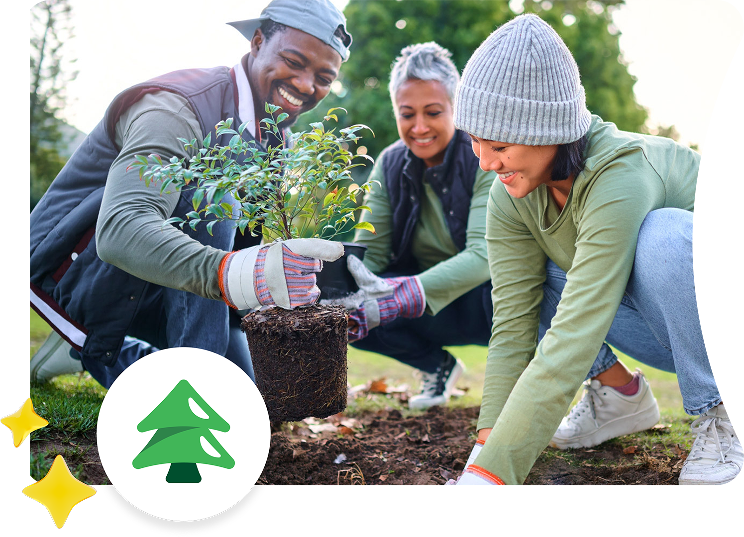 three people planting a tree.