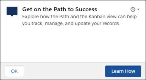 Um prompt flutuante que diz: Entre no caminho do sucesso. Explore como a visualização Path e Kanban podem ajudá-lo a rastrear, gerenciar e atualizar seus registros. Existem dois botões: OK e Aprenda como.