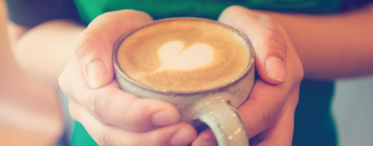 Espresso drink cupped in hands.