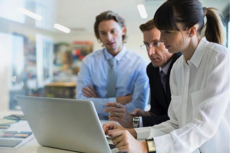 A businesswoman demoing an app for two businessmen