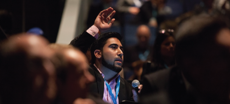 Audience member raising a hand.