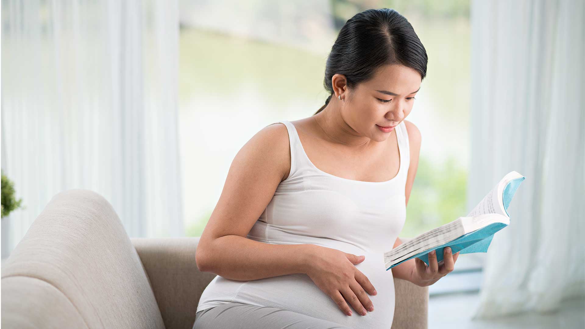 howtoprepareheader woman reading book to prepare for childbirth