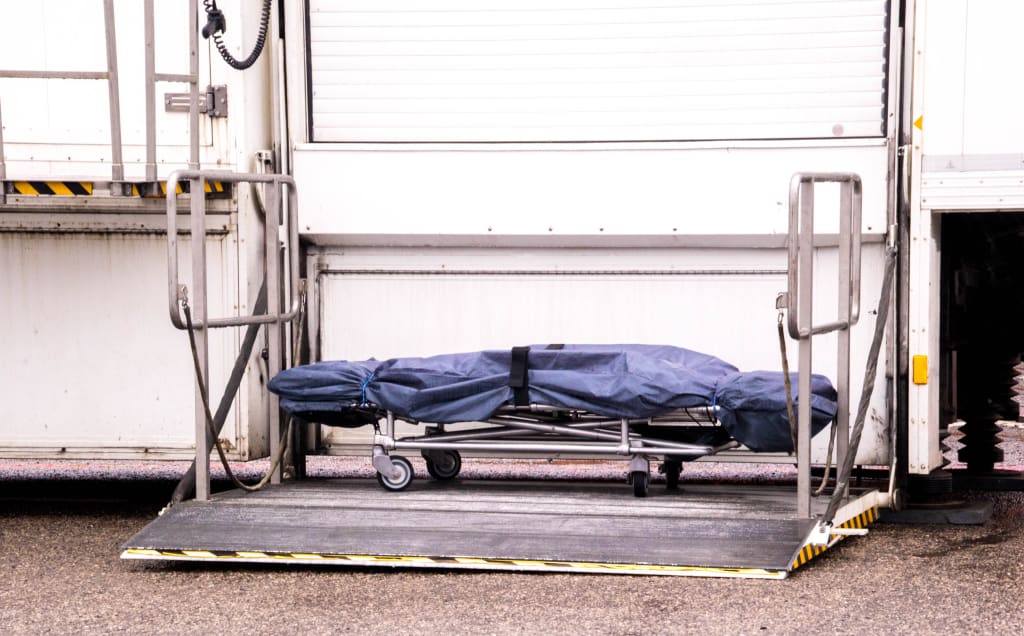 A mortuary stretcher left sat outside a mobile mortuary.