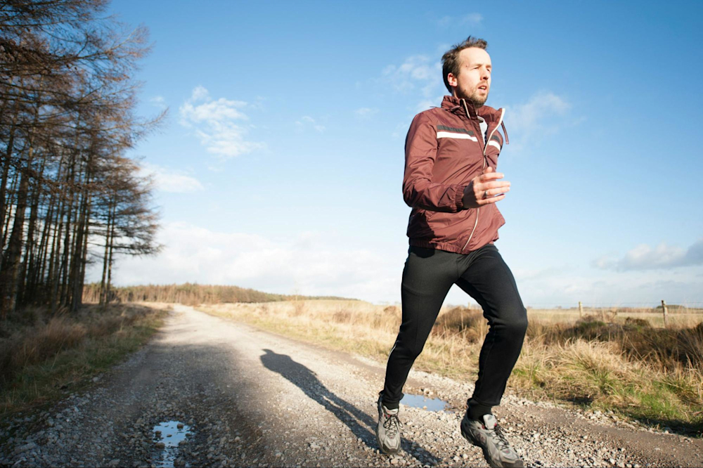 A runner who cross-trains with rowing goes for an outdoor run.