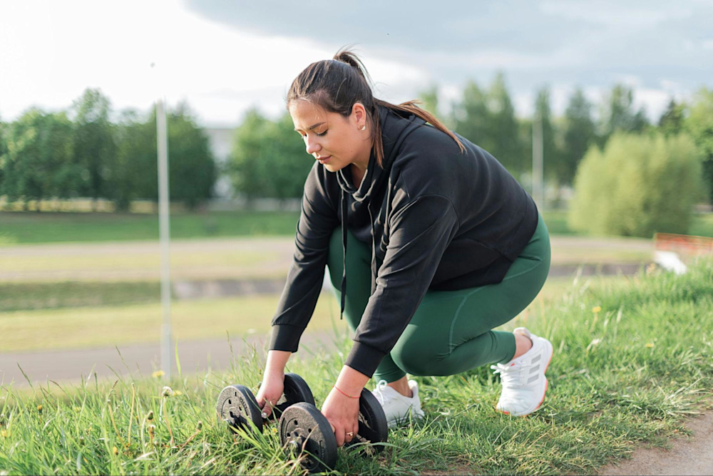 Woman does a resistance training workout outside.