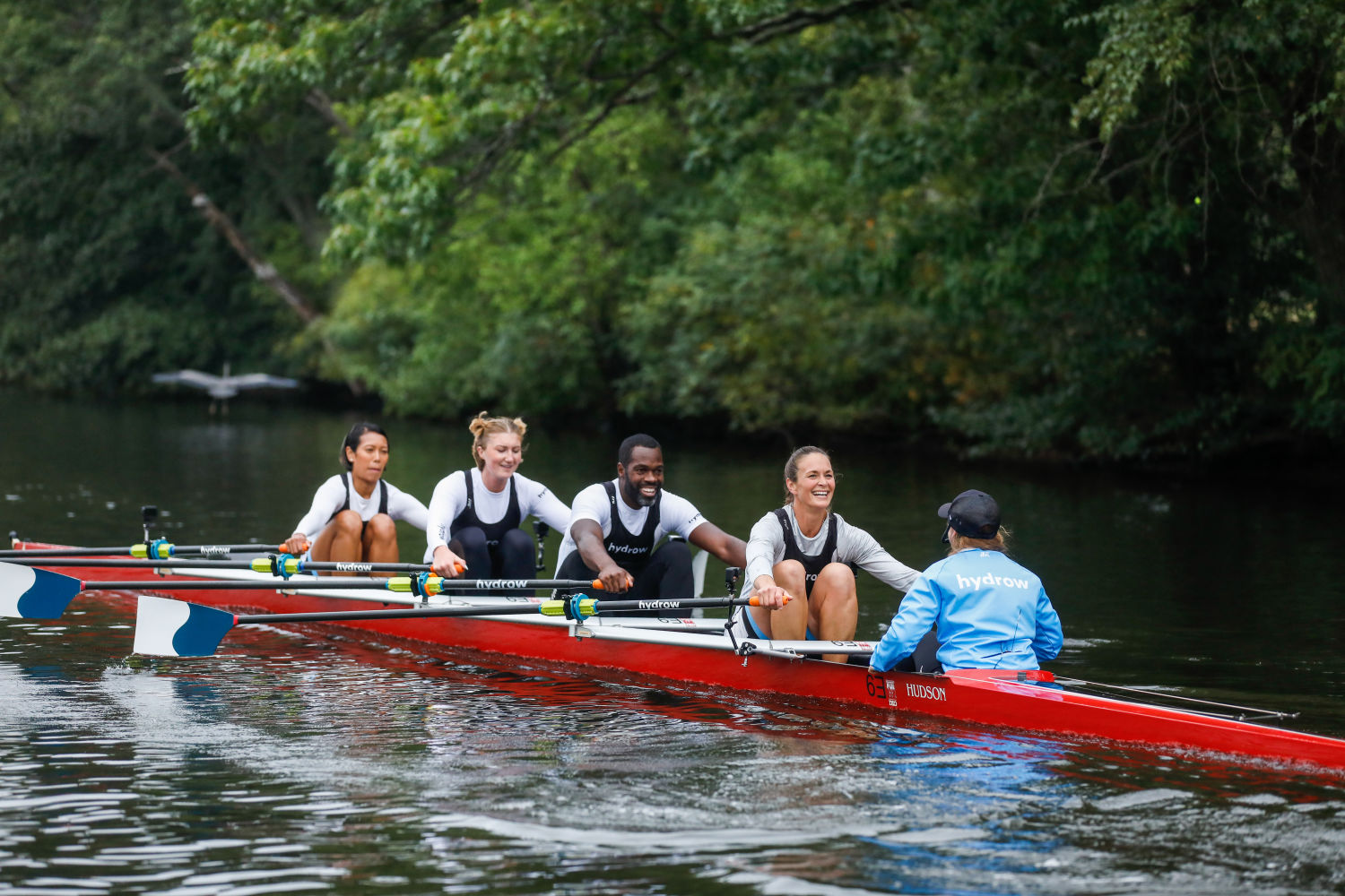 Four people racing on the Charles River in Boston