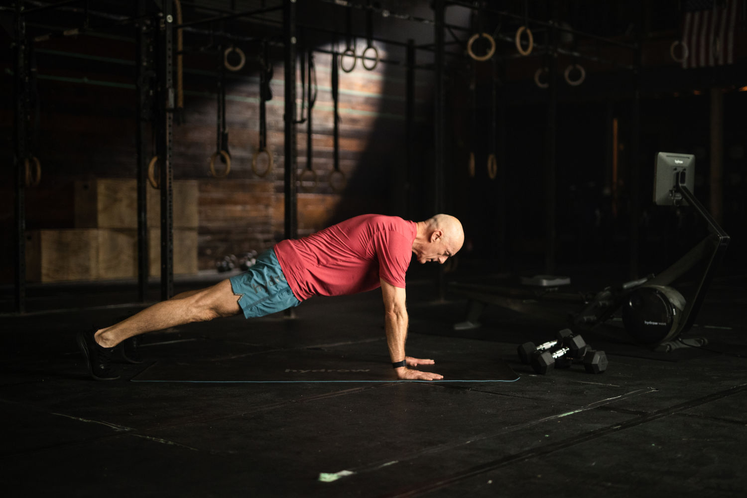 Man working out on a mat in a gym