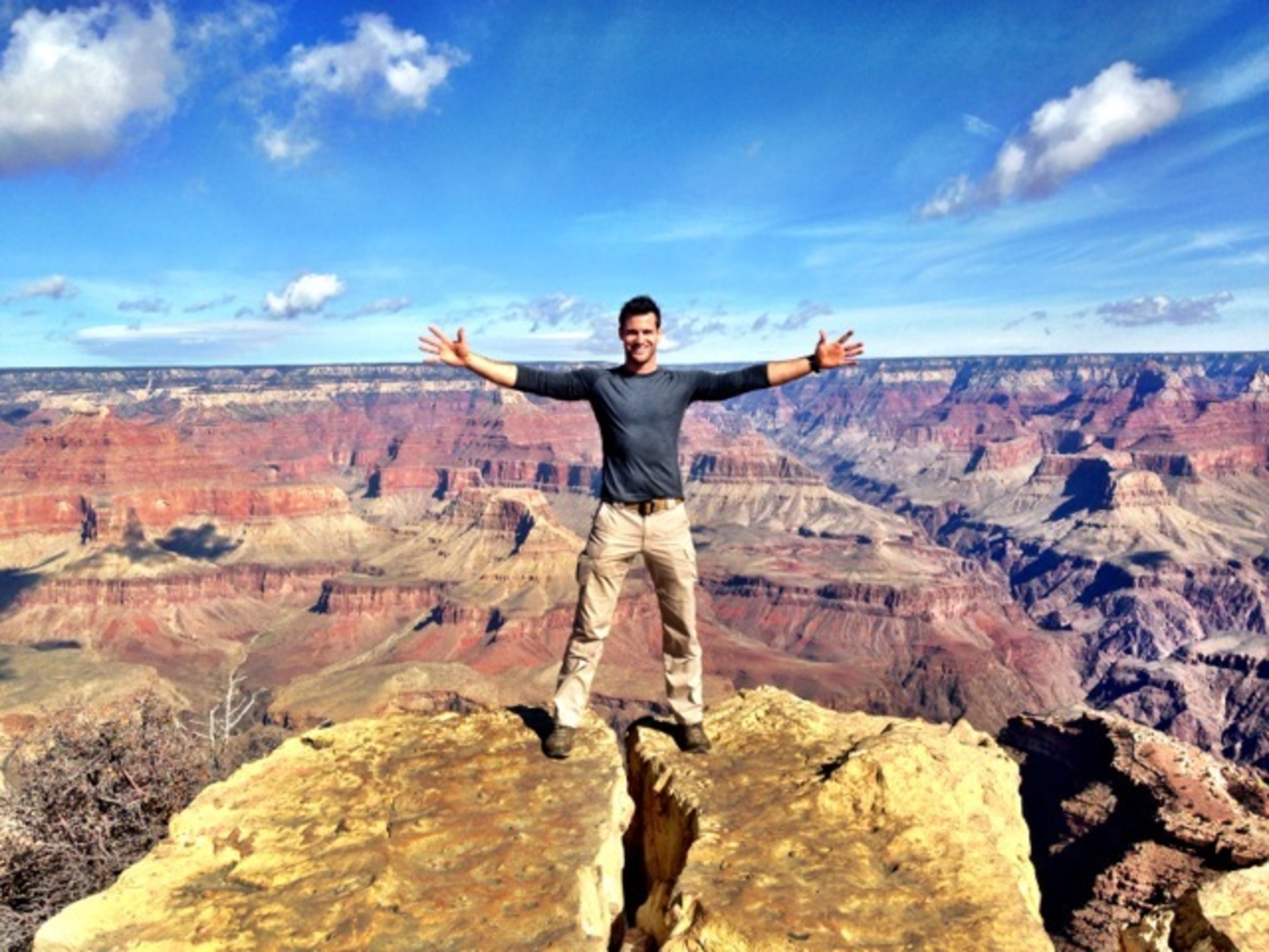 Lance Parker poses on a ledge at the Grand Canyon.