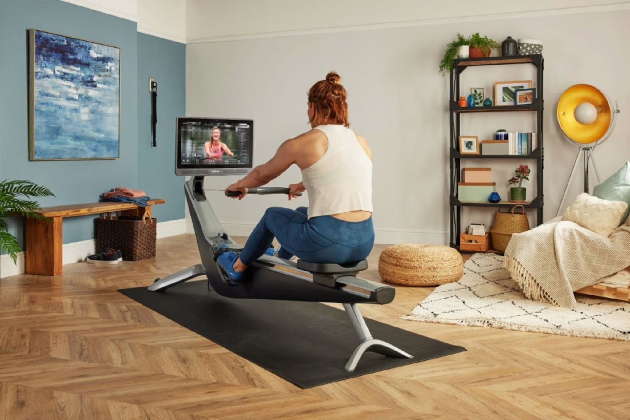 Woman works out on a Hydrow rowing machine after learning whether Hydrow is worth the cost.
