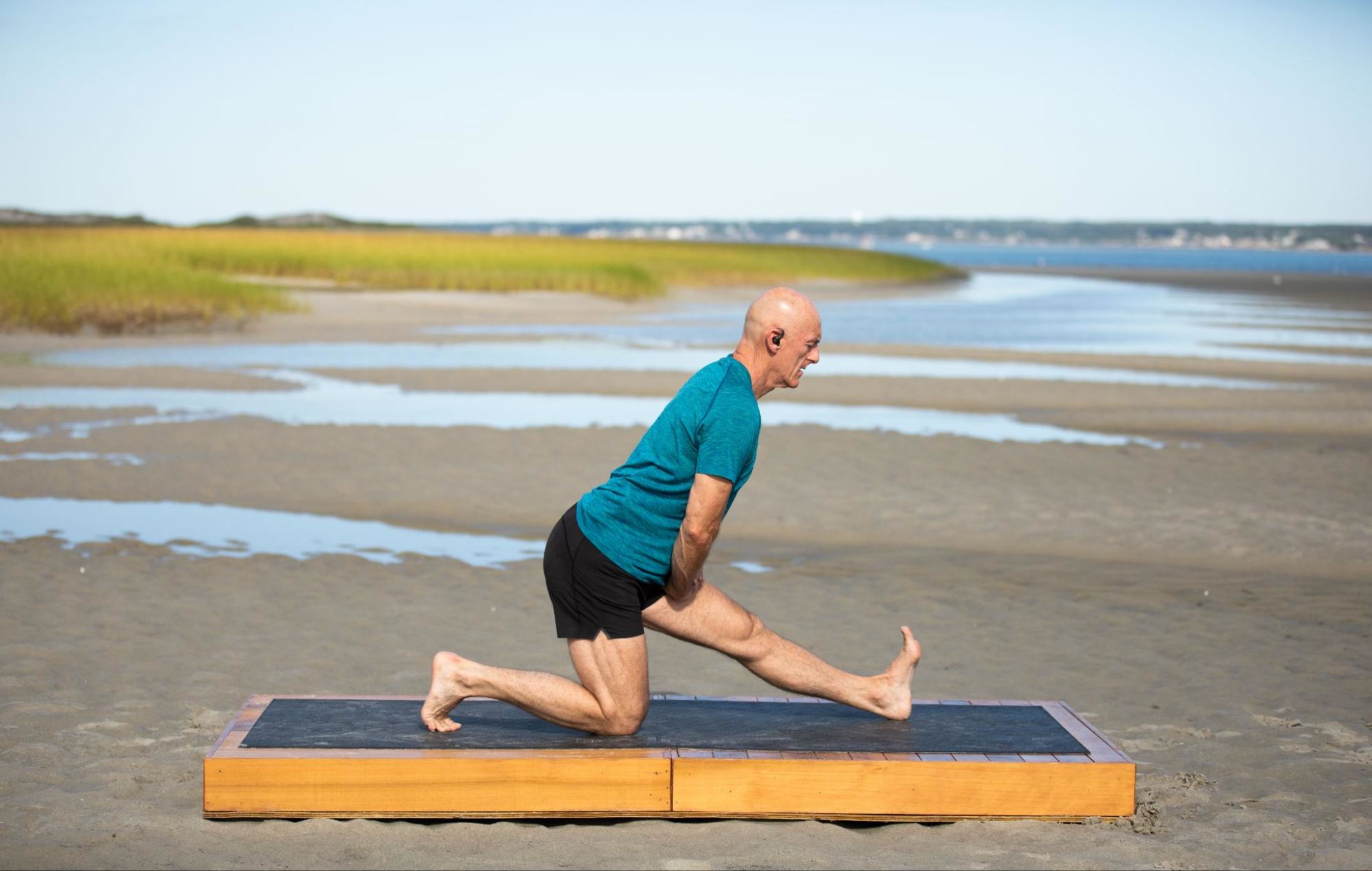 Man does a yoga workout after learning what yoga is and how to get started with his practice.
