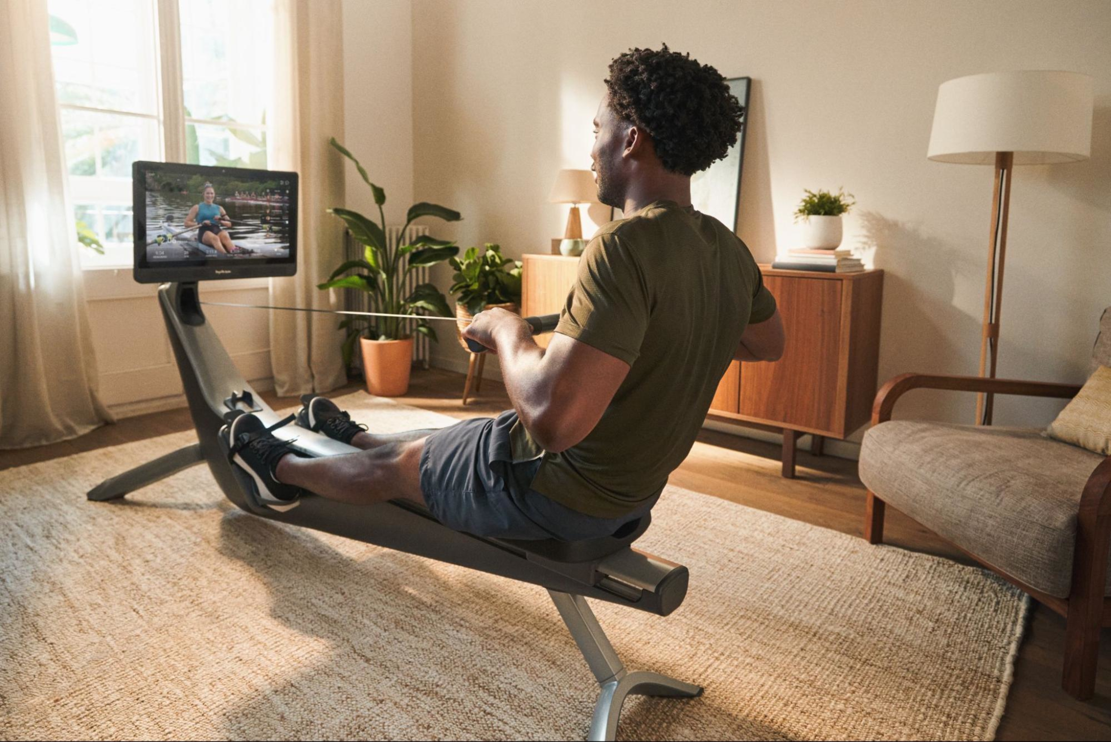 Man rows on a Hydrow rowing machine, known as one of the best home exercise equipment pieces.