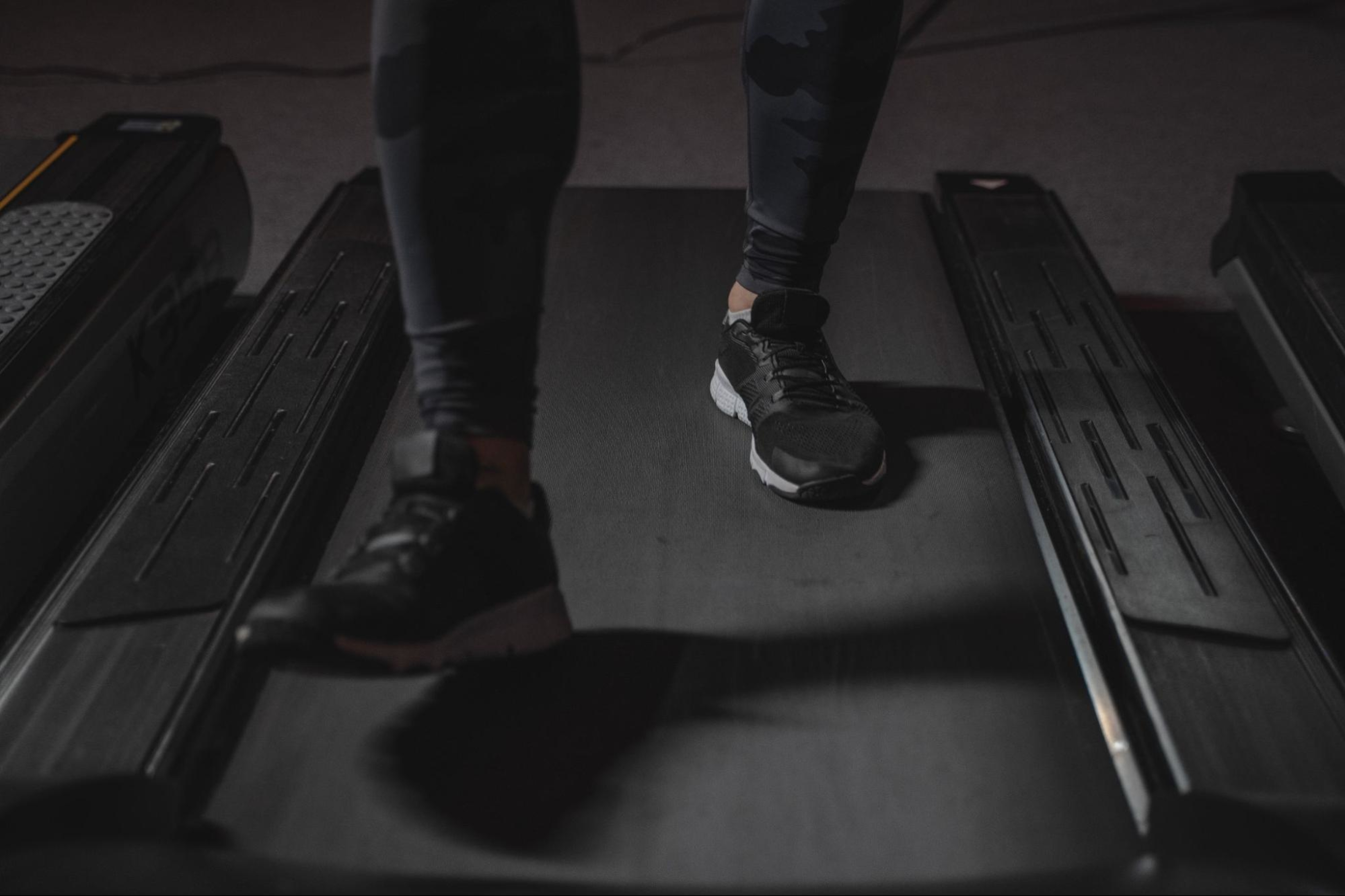 Person runs on a treadmill in their home gym.