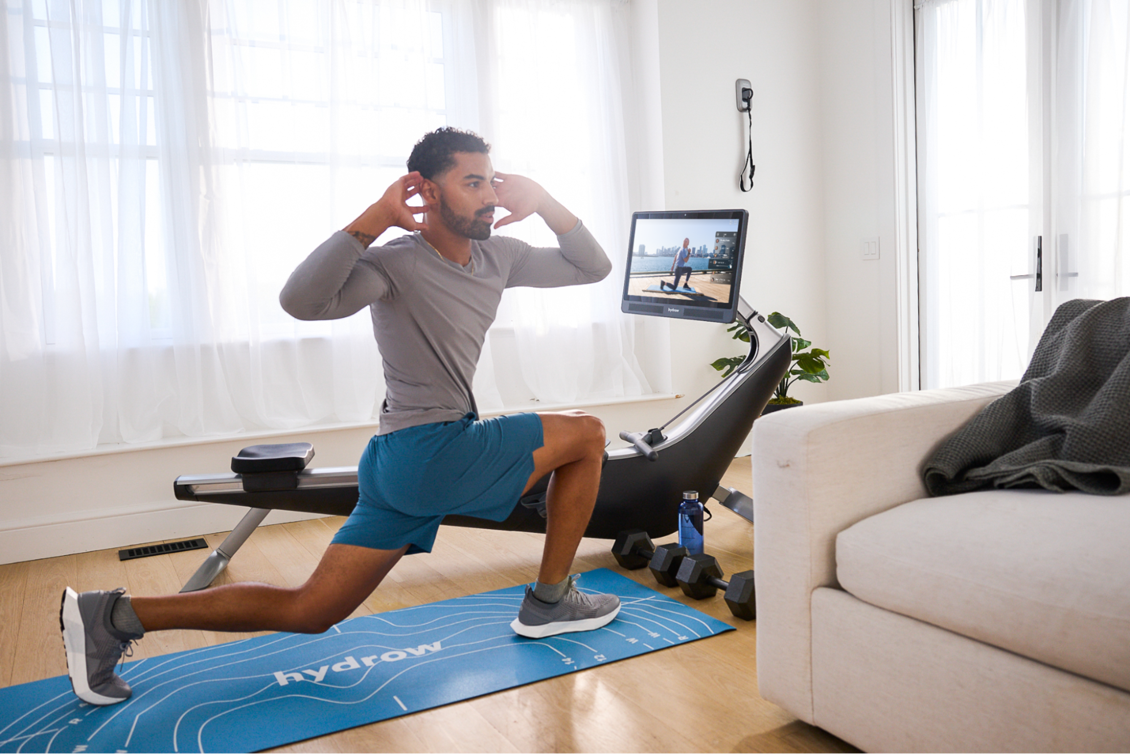 Man does a circuit training workout on and off his Hydrow rowing machine.