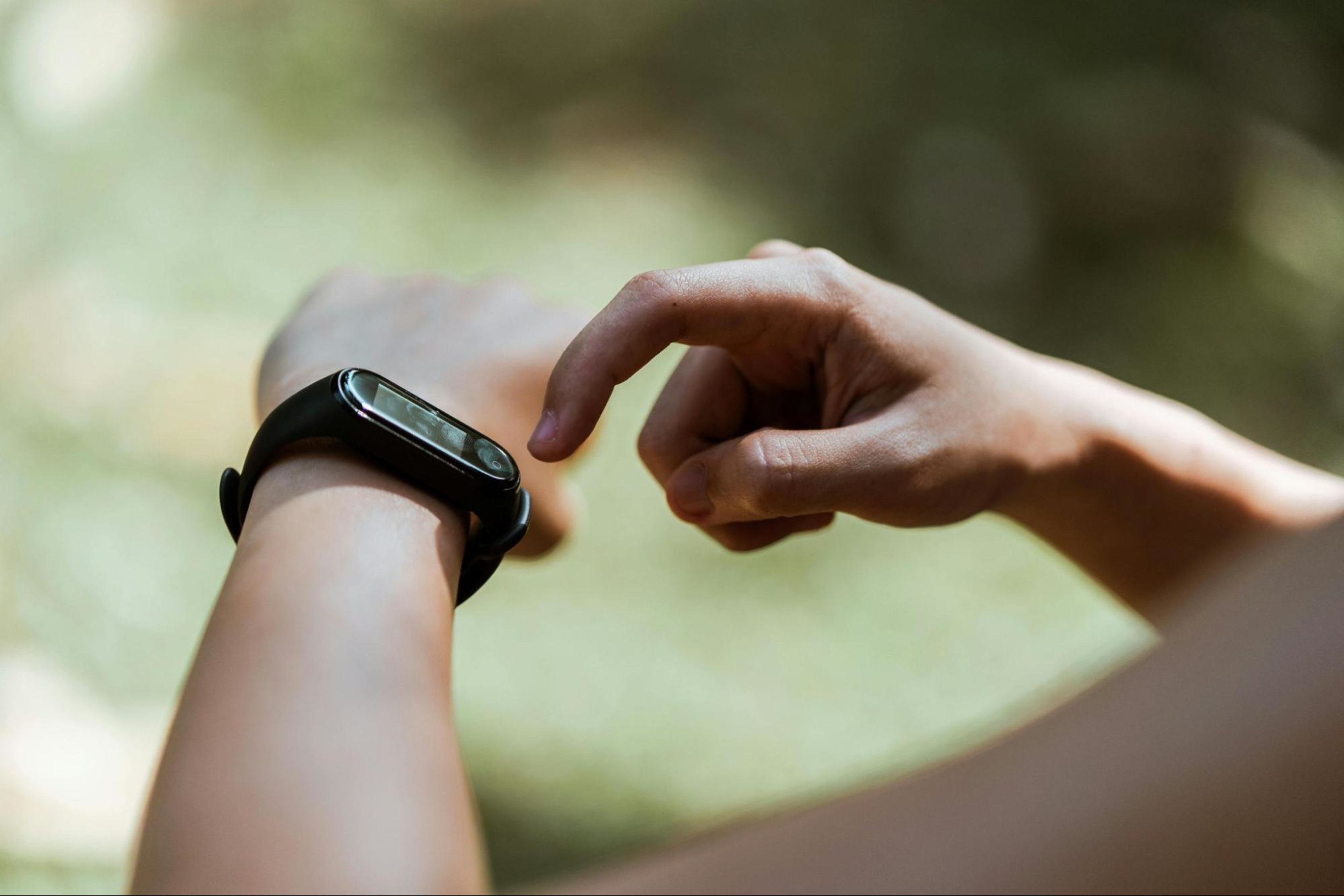 Woman monitors her heart rate during exercise with a wearable fitness monitor.