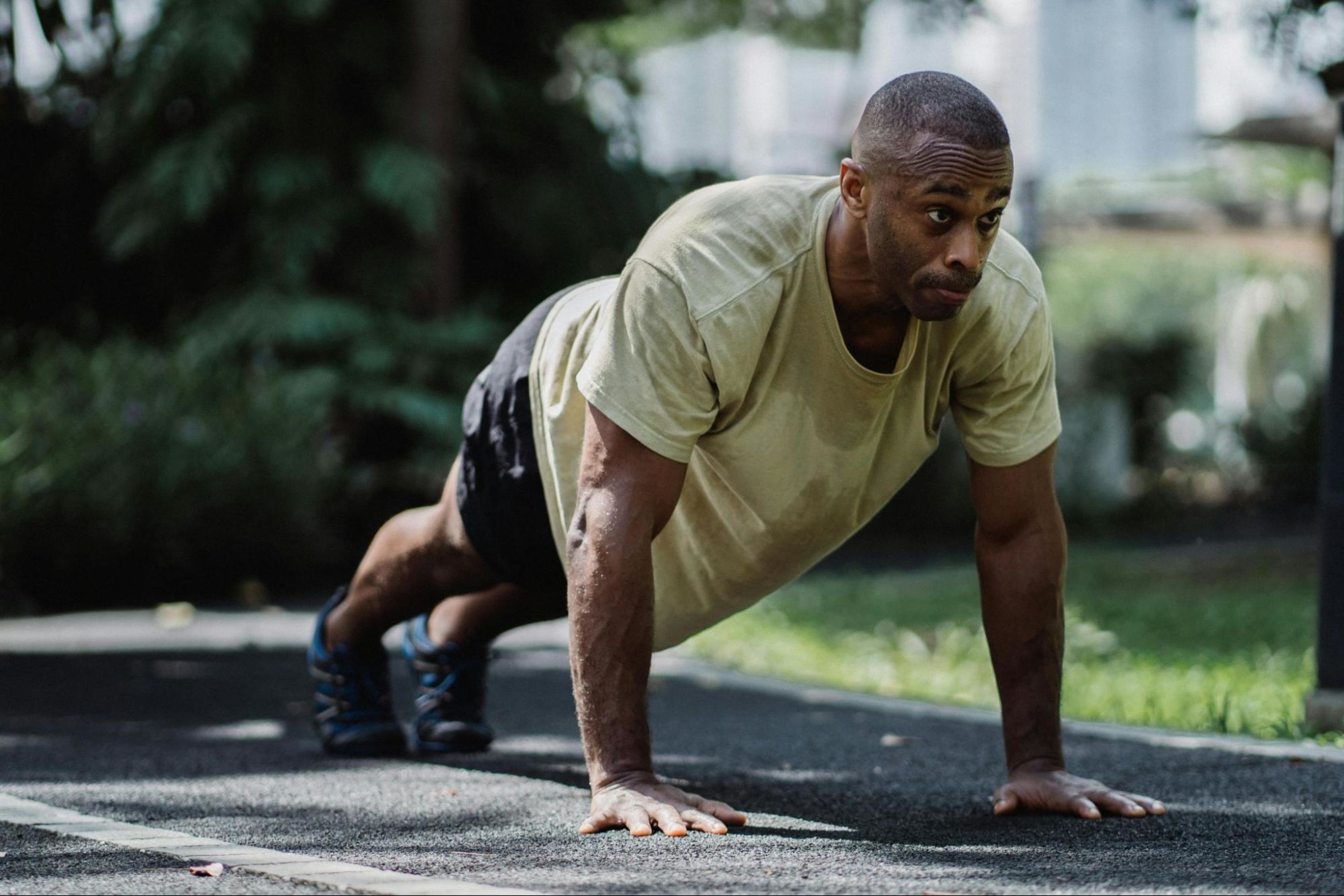 Man does a push-up as part of a full-body 30-minute HIIT workout.