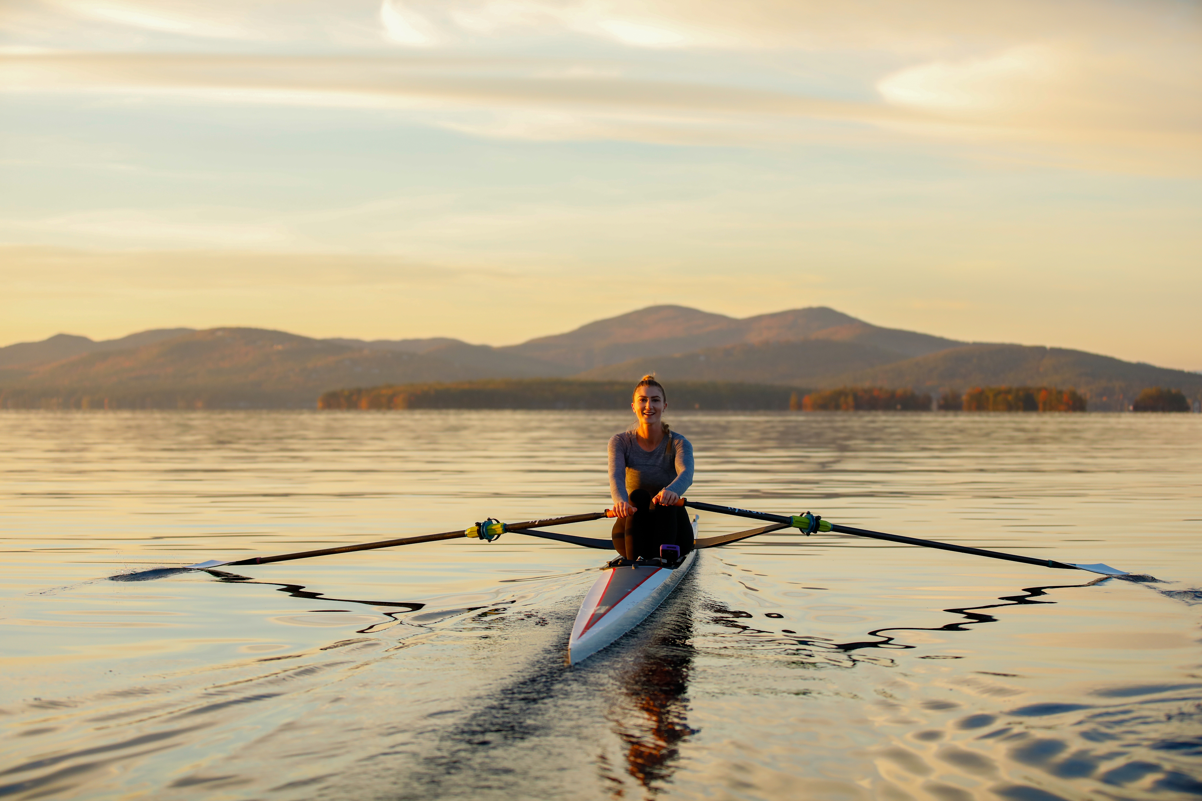 Woman works out on the water to improve her rowing pace.